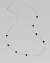 A long sterling silver chain with hammered bead and faceted onyx stations.Onyx Sterling silver Length, about 38 Lobster clasp closure Imported 