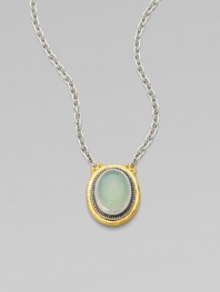 From the Gauntlet Collection. A smooth oval of pastel aqua chalcedony is elegantly framed in granulated sterling silver and hammered 24k gold, on a silver chain.Aqua chalcedonySterling silver and 24k yellow goldChain length, about 18Pendant length, about ¾Imported