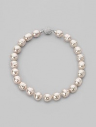 A dramatic yet simple strand of white baroque pearls, with a sparkling clasp of cubic zirconia. 16mm white man-made organic pearls Length, about 17 Sterling silver and cubic zirconia ball clasp Made in Spain
