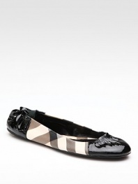 Sleek faux patent leather updates this classic Burberry check style. Leather/PVC upper Rubber sole Padded insole Made in ItalyOUR FIT MODEL RECOMMENDS ordering one half size up as this style runs small. 