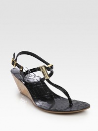 Patent leather t-strap with a natural cork wedge, goldtone T embellishment and adjustable straps. Cork-covered wedge, 2 (50mm)Patent leather upperLeather liningRubber solePadded insoleImportedOUR FIT MODEL RECOMMENDS ordering true size. 
