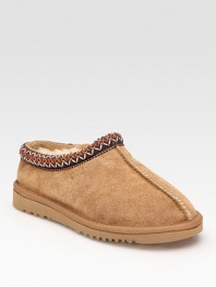 Stay cozy in a this classic suede style with plush shearling lining and embroidered details. Stretch suede upper Shearling lining Foam sole Padded insole Imported