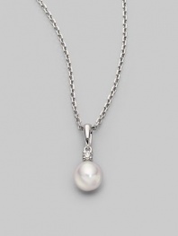 Simple and lovely, a white, round cultured Akoya pearl has a sparkling diamond accent, plus a chain and setting of 18k gold. 7mm white round cultured pearl Quality: A+ Diamond, 0.05 tcw 18k white gold Length, about 18 Spring ring clasp Imported