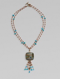 From the Trujillo Collection. Two delicate beaded strands hold a striking plaque of rainbow calsilica encased in rock crystal with a beaded tassel.Turquoise, jasper, rainbow calsilica and crystalBronzeLength, about 29Carved toggle claspMade in USA