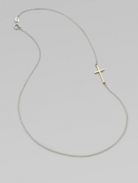 A simple, sleek cross of 14k gold sits sideways within a delicate sterling silver chain in this eloquent design.14k yellow gold and sterling silverLength, about 18Spring ring claspMade in USA