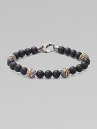 A bold statement in sterling silver and matte onyx with handsome engraved detail. Sterling silver Onyx 8mm beads About 9 long Imported 