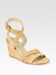 Natural cork wedge with adjustable, woven straps that make their way up the ankle. Cork-covered wedge, 3 (75mm)Straw and cork upperLeather liningBuffed leather solePadded insoleImported