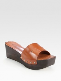Sprinkled in studs, this traditional leather style has a slight wooden wedge and platform. Wooden wedge, 2½ (65mm)Wooden platform, 1½ (40mm)Compares to a 1 heel (25mm)Leather upperLeather lining and solePadded insoleMade in ItalyOUR FIT MODEL RECOMMENDS ordering one half size up as this style runs small. 