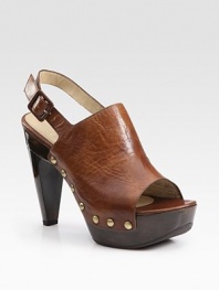 Metal-studded leather and wooden style, defined by a peep toe and adjustable buckle strap. Wooden heel, 5 (125mm)Covered platform, 1½ (40mm)Compares to a 3½ heel (90mm)Metal-studded leather upperLeather liningRubber solePadded insoleImportedOUR FIT MODEL RECOMMENDS ordering true size. 