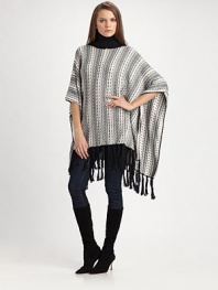 This intricately-woven topper drapes effortlessly over the body for a silhouette of casual chic.Ribbed turtleneck Dropped shoulders Open sleeves Pullover style Fringe trim About 27½ from shoulder to hem 68% cotton/21% nylon/11% alpaca Dry clean Imported