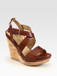 Burnished leather and cork wedge with an adjustable ankle strap and finished with metal hardware. Self-covered wedge, 5¼ (130mm)Covered platform, 1¼ (30mm)Compares to a 4 heel (100mm)Leather upperLeather liningRubber solePadded insoleImported