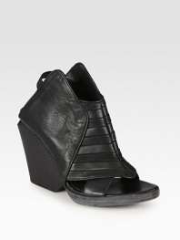 Futuristic leather design with an open front and comfortable elastic straps. Stacked wedge, 4 (100mm)Stacked platform, ½ (15mm)Compares to a 3½ heel (90mm)Leather and elastic upperLeather lining and solePadded insoleMade in ItalyOUR FIT MODEL RECOMMENDS ordering one size up as this style runs small. 