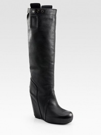 Exquisite leather knee-high wedge with an adjustable leg circumference and intricate stitching. Self-covered wedge, 4 (100mm)Covered platform, 1 (25mm)Compares to a 3 heel (75mm)Shaft, 17Adjustable leg circumference, 15Leather upperPull-on styleLeather lining and solePadded insoleMade in ItalyOUR FIT MODEL RECOMMENDS ordering one half size up as this style runs small. 