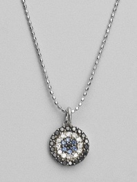 Rings of mysterious black diamonds, sparkling white diamonds and cool blue sapphires make a glamorous pendant set in 14k white gold. Diamonds, 0.26 tcw Sapphires 14k white gold Chain length, about 16 Medallion diameter, about ½ Lobster clasp Imported