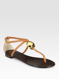 Rich leather t-strap with an adjustable, wrap-around ankle strap and a gleaming goldtone adornment. Leather upperLeather lining and solePadded insoleMade in ItalyOUR FIT MODEL RECOMMENDS ordering true size. 
