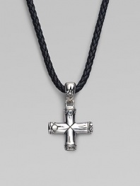 A handsomely crafted sterling silver cross pendant hangs from a finely braided leather necklace. Adjustable necklace, 18-20 Imported