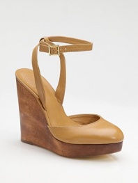 A richly stained wood wedge and platform sit underneath a leather sandal with a shapely closed toe and slender ankle strap.Wood wedge, 5½ (140mm) Wood platform, 1 (25mm) Compares to a 4½ heel (115mm) Buckle ankle strap Leather lining and sole Padded insole ImportedOUR FIT MODEL RECOMMENDS ordering one half size up as this style runs small. 