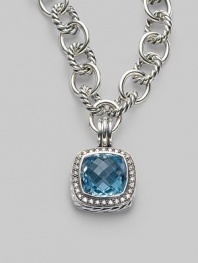 A sparkling faceted blue topaz, surrounded by pavé diamonds, sits in a squared setting of sterling silver with a cabled edge and fluted bale. Blue topaz Diamonds, 0.45 tcw Sterling silver with a black rhodium finish About ¾ square Spring clip clasp Made in USA Please note: Necklace sold separately.