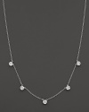 Five diamond cluster stations in a 14K white gold necklace.