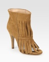 Trendy fringe and a peep toe complement this ankle-grazing suede style. Self-covered heel, 4 (100mm)Suede upperPull-on styleLeather lining and solePadded insoleMade in ItalyOUR FIT MODEL RECOMMENDS ordering one half size up as this style runs small. 