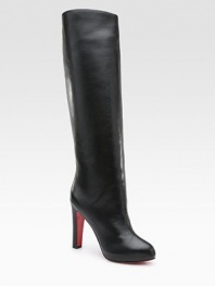Lustrous leather knee-high style with a covered heel and platform. Self-covered heel, 4 (100mm) Covered platform, ¾ (20mm) Compares to a 3¼ heel (80mm) Shaft, 17 Leg circumference, 14 Leather upper Pull-on style Leather lining Signature red leather sole Padded insole Made in Italy