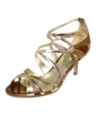 Light a spark. The Elkie evening sandals by Ivanka Trump feature curved straps in metallic tones of luxe leather.