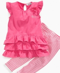 Keep her cozy and cute in ruffles and stripes with this darling tunic and leggings set from DKNY.