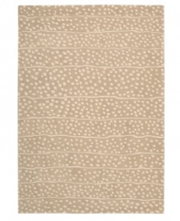 A blizzard of soft spots linger in between imperfect lines, creating beautiful harmony against a gentle sand-hued ground. Hand tufted from 100% natural wool, this plush Calvin Klein rug is crafted using the cut-and-loop pile technique that creates a unique matte surface texture.