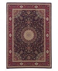 A beautiful example of an ancient Persian ardebil carpet, this rug features a medallion design ringed with tiny flowers. A deep navy ground exquisitely offsets the springlike palette of yellows, blues, greens and purples.