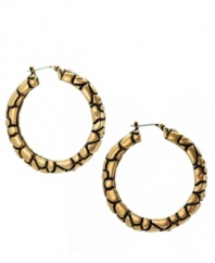 Hip hoops! T Tahari amps up the look of classically chic hoop earrings with python embossment and sparkling Colorado crystals. Crafted in antique gold tone mixed metal. Approximate diameter: 1 inch.