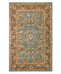 A choice color blue behind a myriad of intricate and vibrant floral medallions creates a simply elegant and rich Persian-inspired rug from Safavieh. Hand-tufted and woven from pure wool by experienced artisans in India, it makes a refined statement wherever placed. (Clearance)