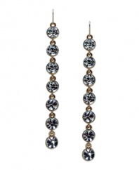 Shine on in red carpet-worthy style. GUESS's sparkling linear drop earrings feature round-cut crystals in shiny gold tone mixed metal. Approximate drop: 3-1/2 inches.