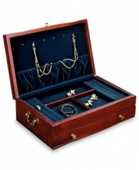 Royal blue lining provides the perfect backdrop for your cherished jewelry in this elegant cherry wood jewelry box. Solid brass drawer pulls and brass-finished side handles add a traditional touch.