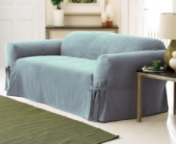 Soft, stylish and sophisticated, the Soft Faux Suede loveseat slipcover from Sure Fit will energize your upholstery and home with modern flair. Designed with broad arms, inner pleating and a drape skirt with ties for an easy update.