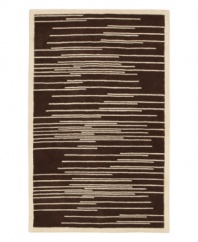 Light and dark tones of brown and beige collide to produce this dynamic piece, designed by Surya's world-renowned artisans. Transforming any decor from static to stirring, the Studio Rowe area rug uses hand-tufted New Zealand wool to create an ultra-soft surface that lasts in the most high-traffic environments.