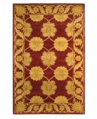 A golden vine-and-floral motif creates exquisite contrast against a deep maroon ground, adding fine finesse to this plush area rug from Safavieh. Tufted in India from pure wool, this rug evokes classic Persian designs in a bold, bright color palette for the contemporary home. (Clearance)