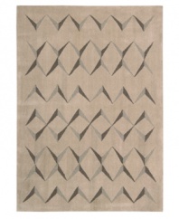 This visually arresting area rug has a simple design that casts striking shadows against a soft beige background. Hand tufted from 100% natural wool, this plush Calvin Klein rug is crafted using the cut-and-loop pile technique that creates a unique matte surface texture.