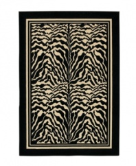 Bring the exotic landscape of the African Serengeti to you living space with this eye-catching zebra print rug. Four panels of black and white zebra stripes stand is stark contrast to each other, framed by a black border. The thick power-loomed pile presents a soft, luxurious finish and heaviness virtually indistinguishable from the work of master artisans. Made with meticulous detail of ultra-fine fiber that resists wear and permanent stains. One-year limited warranty.