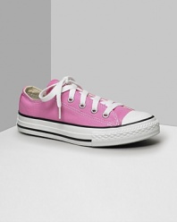 Low cut Converse All Stars. This classic canvas sneaker set the standard in cool and comfort. Available in pink. With lace-up canvas uppers, contrast stitching and rubber sole and toe.