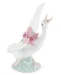 With her beak to the sky and a bouquet of orchids in tow, this graceful duck is on the move in magnificent Lladro porcelain.