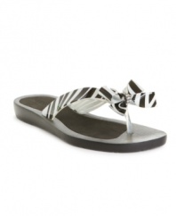 GUESS dresses up the classic flip flop with a decorative bow for a sweet touch.