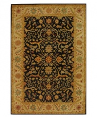 Enjoy a thousand years of rug-making tradition -- set against a bold black ground -- with this striking area rug from Safavieh. Tufted in India from pure wool, this rug emerges from the annals of antiquity to bring spectacular style and time-honored quality to your home. (Clearance)