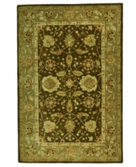 Traditional Turkish designs delight the eye in a winsome arabesque bordered motif, featuring vines, branches and blossoms flowing freely in rich green and brown tones. Pure wool is hand-tufted in a thick three-quarter-inch pile, finished with a cotton backing for long-lasting durability.