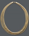 Strands of spun gold. This unique necklace highlights eight strands of gold tone silicone with a 14k gold clasp. Approximate length: 18 inches.