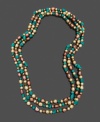 Add a long layer of elegance with a hint of tropical color. Necklace features dyed chocolate cultured freshwater pearls (5-8 mm) and turquoise chips. Approximate length: 64 inches.