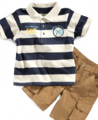 Classic style for a classic kid. He'll be an all-around style star in this polo shirt and cargo short set from Calvin Klein.