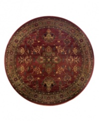 A truly charming interpretation of a traditional carpet, this round rug features a center medallion ringed by palmettes and floral details in sage green, topaz and slate blue against a rich burgundy ground. Striated effects create the weathered look of handmade rugs in a stain-resistant, no-shed manmade fiber.