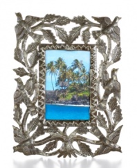 Painstakingly cut, hammered and varnished by hand, this meaningful picture frame displays your favorite people and places in the tree of life. Steel from recycled barrels gives each one-of-a-kind piece a rustic beauty perfected by Haiti's master artisans.
