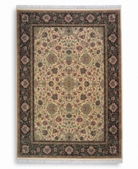 Inspired by the easily recognizable and intricately beautiful textiles of the Kirman region of ancient Persia, this Indo-Kirman rug features graceful floral designs in a rich palette of individually-dyed colors including indigo, soft blues, peach-corals, golds, lavender, and a multitude of soft greens. Patterned on an antique carpet woven circa 1910, it has a soft luster-wash that imparts a soft vintage finish.