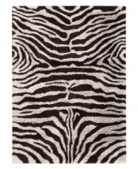 Exotic designs will be the pride of your decor. Adorned with zebra stripes in black and white, this Nourison rug has a marvelously soft and shaggy pile that's hand-tufted from premium-quality yarns. Beautiful in appearance and plush underfoot, this area rug creates an atmosphere of casual elegance.